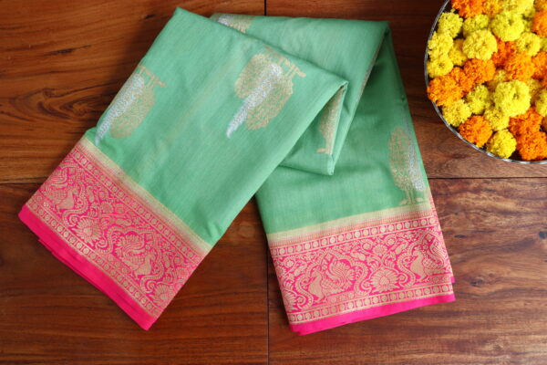 Lite green dupion silk saree with contrast peacok border